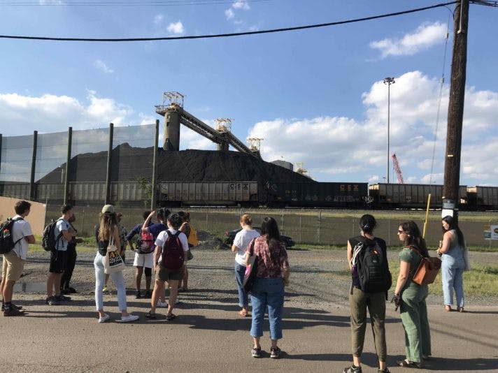 COURTESY OF TOMISIN LONGE
Students in the sustainable design practicum course observe a coal pile in Curtis Bay.
