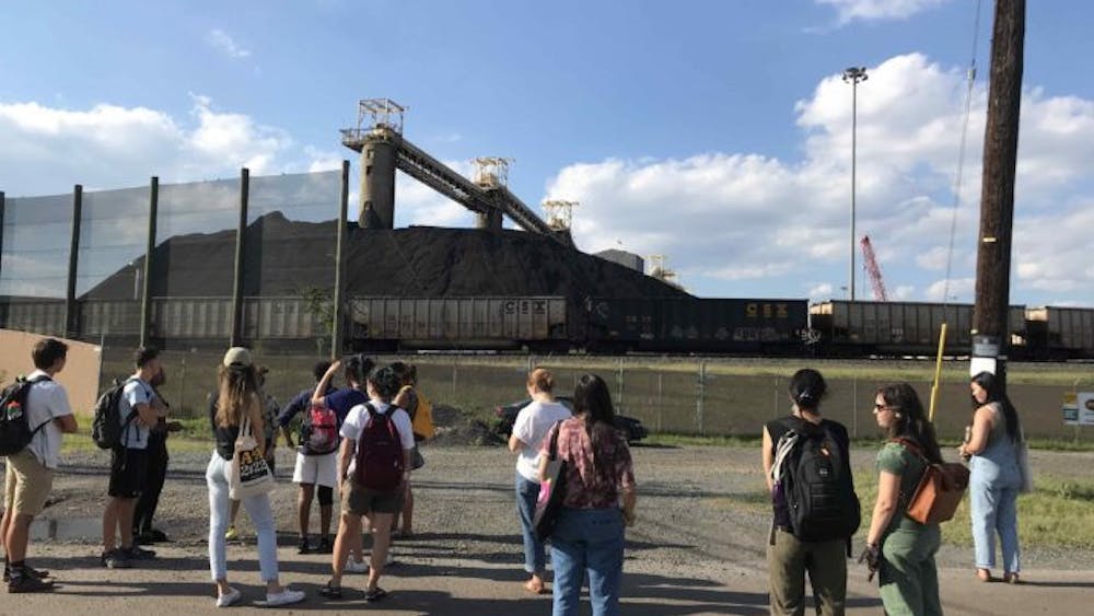 COURTESY OF TOMISIN LONGE
Students in the sustainable design practicum course observe a coal pile in Curtis Bay.
