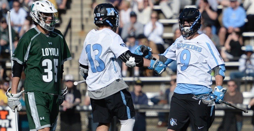 hopkinssports.com
Senior Wilkins Dismuke and sophomore Kyle Marr celebrate the win.