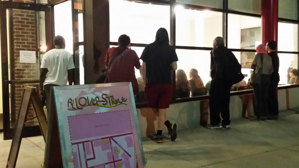 COURTESY OF JACOB TOOK
Participants of Alloverstreet gather at Gallery CA to view Bobby English, Jr.’s I AM You ARE installation.