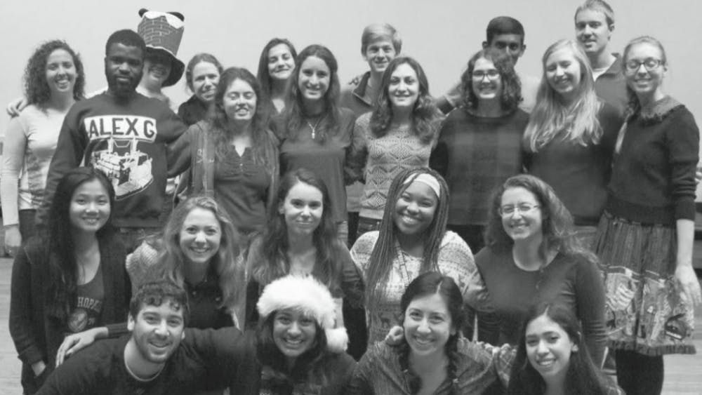  STAFF PHOTO
Last year’s News-Letter editors, numbering over twenty, pose for a staff photo at the holidays.
