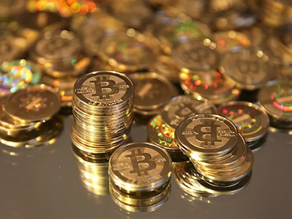A pile of Bitcoins that were just made are arranged for a photograph in Sandy, Utah, U.S., on Friday, April 12, 2013. Created four years ago by a person or group using the name Satoshi Nakamoto, Bitcoin is a virtual currency that can be used to buy and sell a broad range of items -- from cupcakes to electronics to illegal narcotics. Photographer: George Frey/Bloomberg via Getty Images