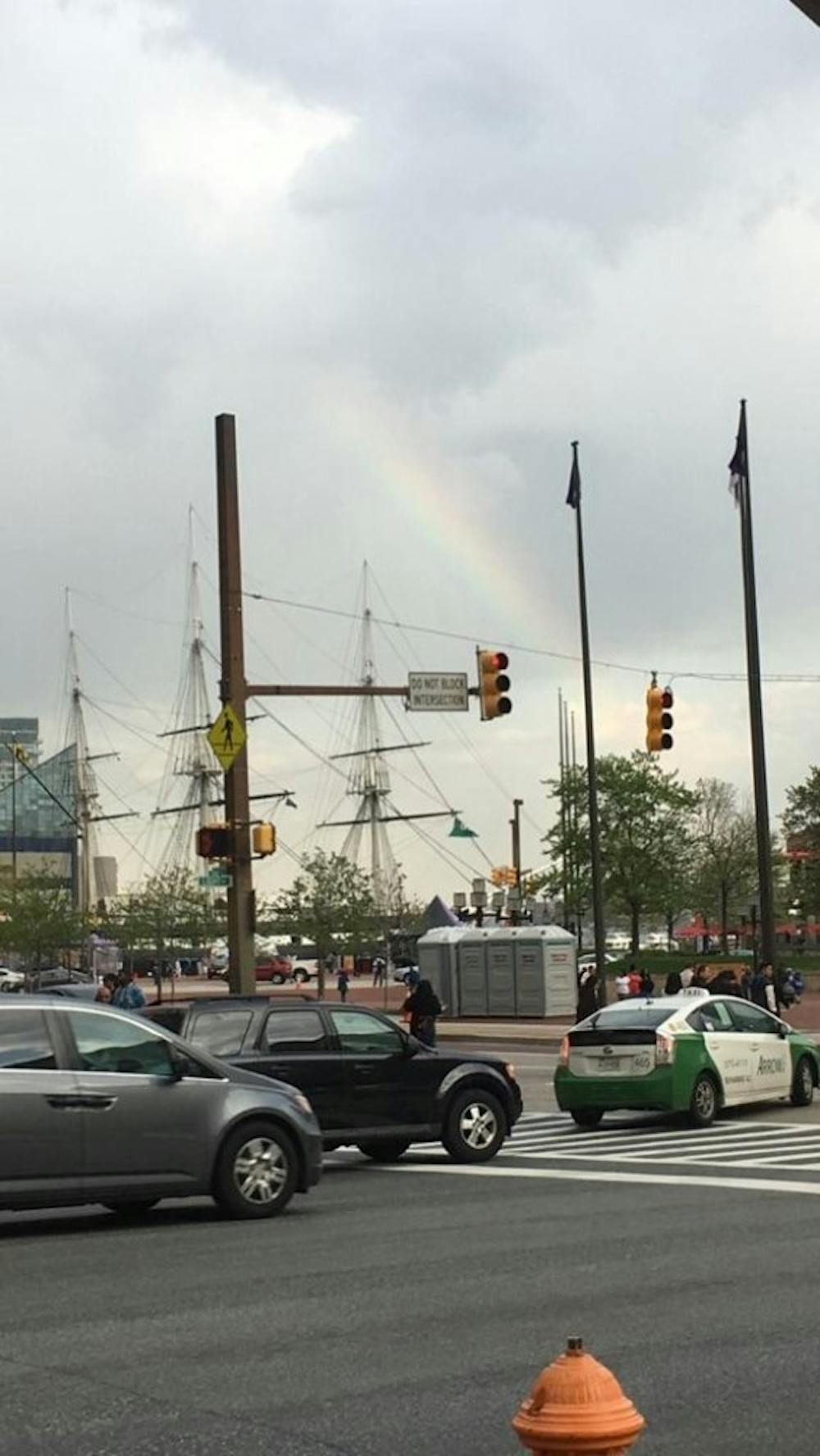 &nbsp;
COURTESY OF RENEE SCAVONE
A streetside view of shipmasts under a rainbow at the Inner Harbor.