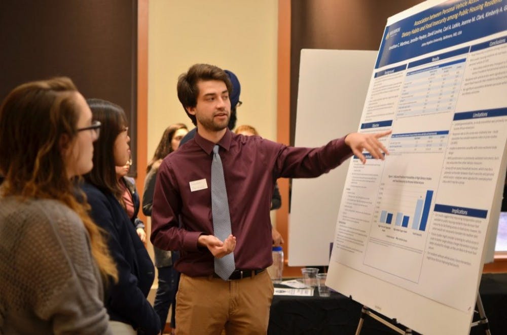  COURTESY OF SANDRA HONG
Senior Jonathan Martinez presents on food insecurity and diet habits among public housing residents.
