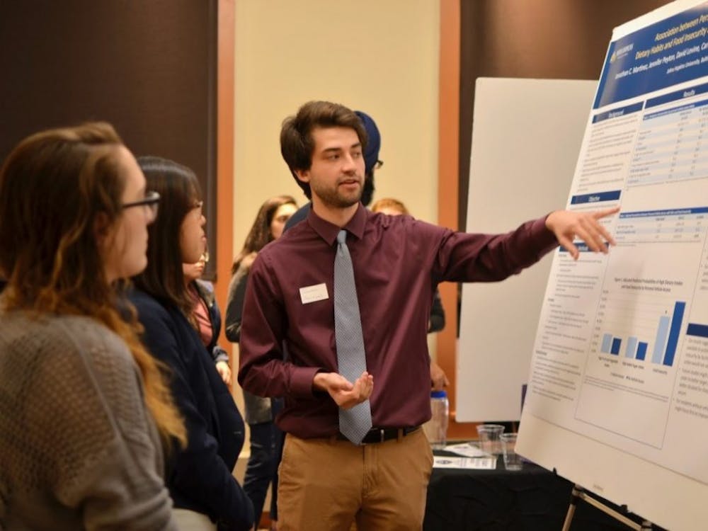 COURTESY OF SANDRA HONG
Senior Jonathan Martinez presents on food insecurity and diet habits among public housing residents.