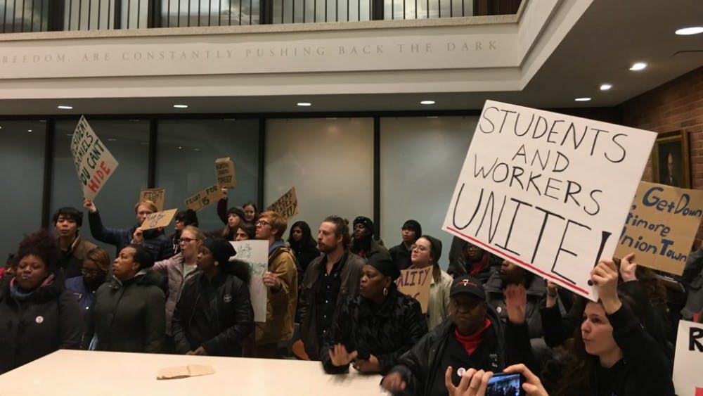 COURTESY OF SAM FOSSUM
Protesters told Daniels “You can’t hide! We can see your greedy side.”