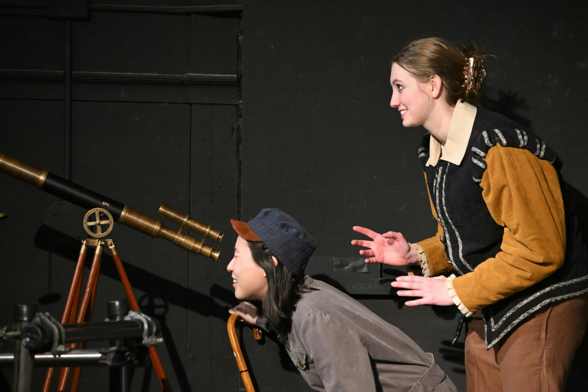 COURTESY OF WILL KIRK
The mechanic, Federzoni (Asa Woo; left), takes a look at the cosmos through Galileo's (Katherine Budinger; right) amplified adaptation of the telescope.