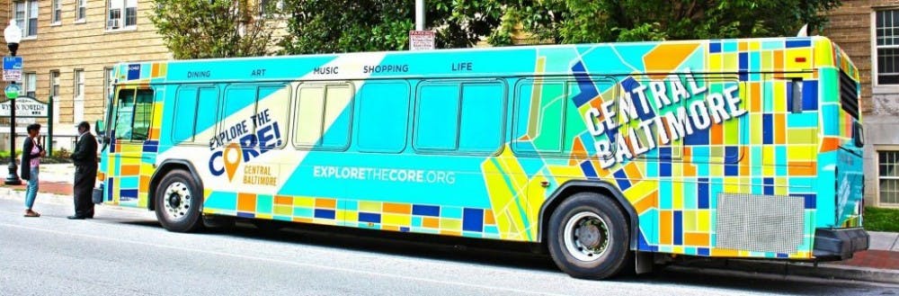  COURTESY OF EXPLORE THE CORE! CENTRAL BALTIMORE
The new stickers on the JHMI buses advertise the Homewood Community Partners Initiative’s campaign to invest in Baltimore.