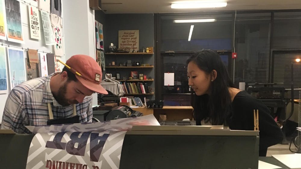 COURTESY OF DORA MALECH
Owner Kyle Van Horn demonstrates how to use one of BPS’s letterpresses.