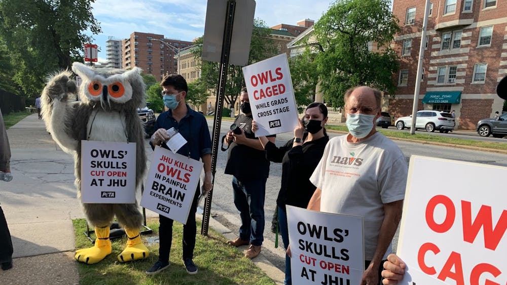 COURTESY OF TASGOLA BRUN
PETA protesters, including an owl mascot, lined the entrance to the University’s commencement celebration on Thursday evening.