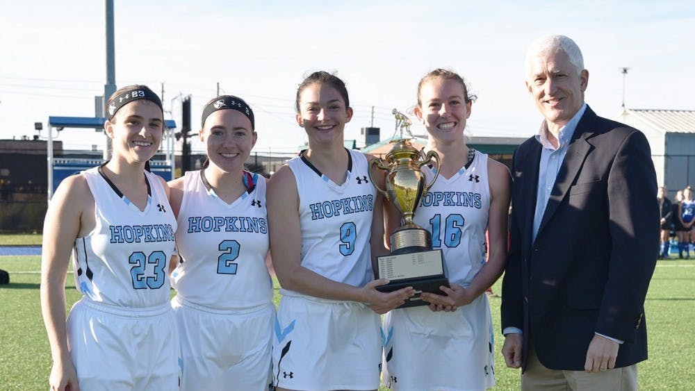 COURTESY OF HOPKINSSPORTS.COM

The seniors on the field hockey team receive the Centennial Conference Tournament trophy after defeating F&M in penalty strokes.