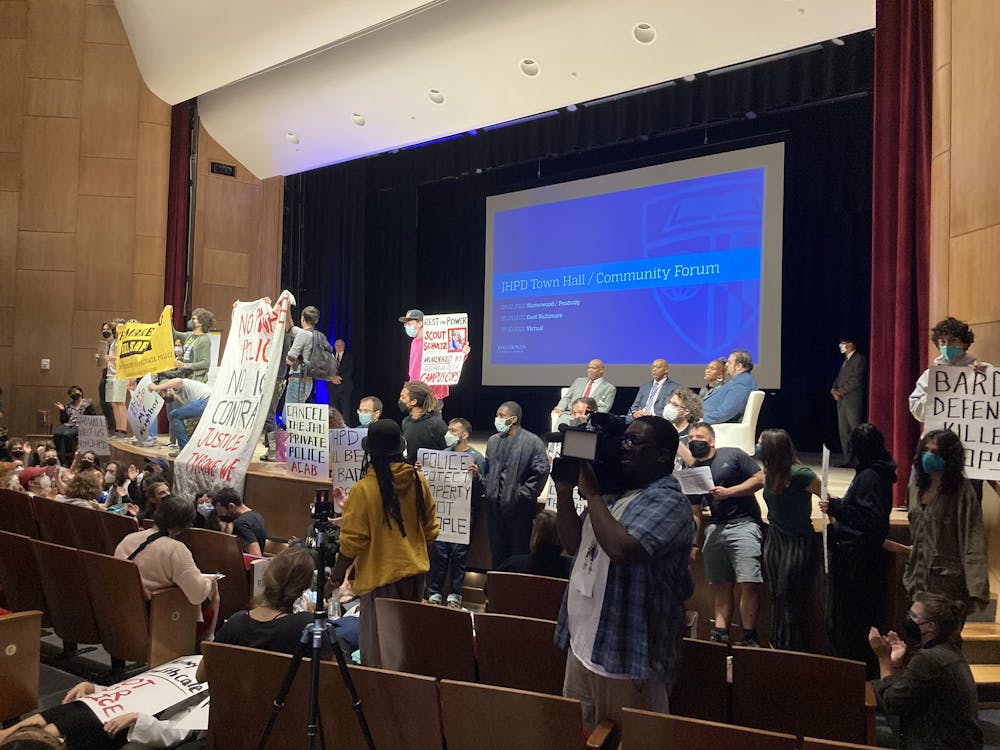 COURTESY OF JULIAN LASHER
Protestors out-voiced town hall panelists and followed Vice President for Public Safety Dr. Branville Bard Jr. out of the event space.