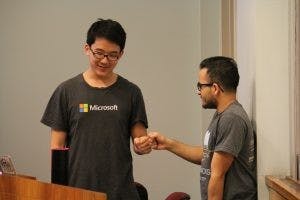  COURTESY OF SIMON ENAGONIO
Senior Richard Chen and freshman Aditya Murali celebrate after finishing their project.