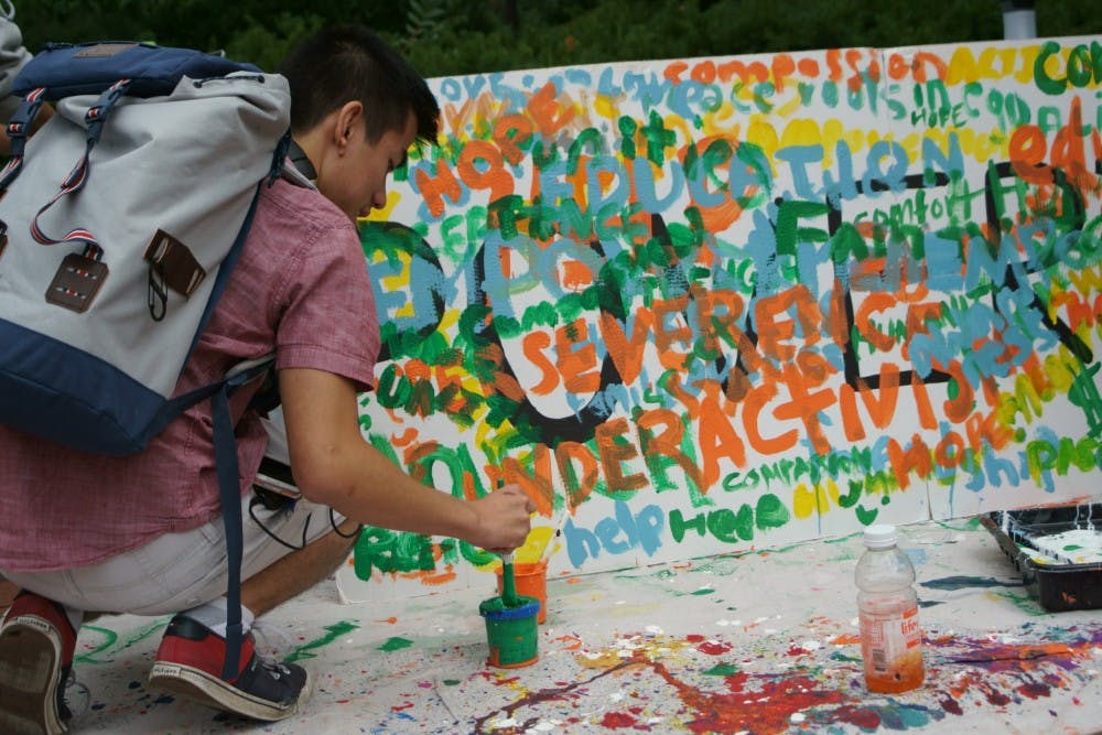COURTESY OF NANCY WANG
Students painted words associated with poverty outside Levering.