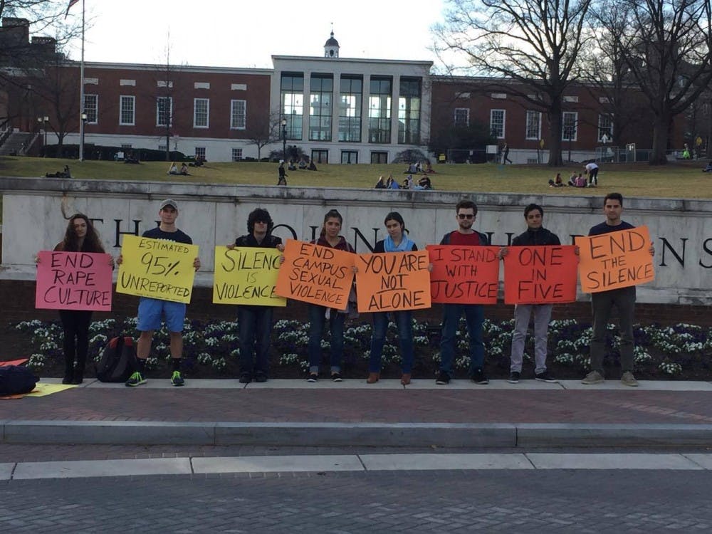 COURTESY OF NEHAL AGGARWAL
Students gathered in front of the Hopkins sign to protest sexual assault and call for transparency. 