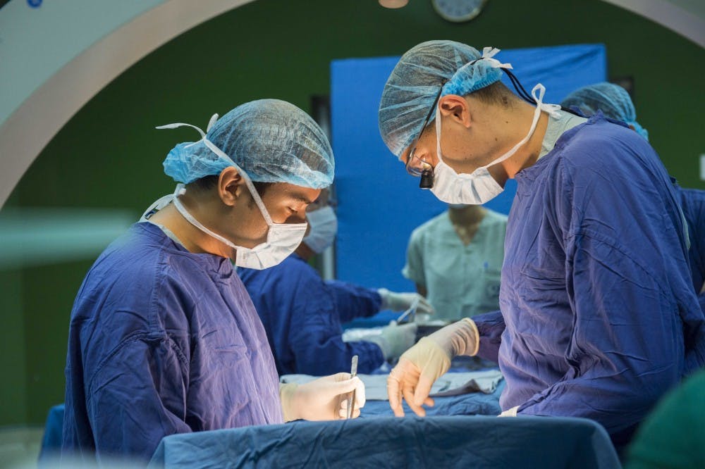 160722-N-BB534-451 DA NANG, Vietnam (July 22, 2016) Dr. Trung Kieu Huy Le (left), a neurosurgeon at Da Nang General Hospital, and Lt. Cmdr. Paul Porensky, a neurosurgeon assigned to Pacific Partnership 2016, perform neurosurgery during a cooperative health engagement (CHE). During the CHE Porensky worked together with local surgeons to diagnose patients and perform surgeries. Pacific Partnership is in Da Nang where hospital ship USNS Mercy (T-AH 19) is joined by JS Shimokita (LST-4002) and Vietnam People's Navy ship Khánh Hóa. Partner nations are working work side-by-side with local organizations to conduct cooperative health engagements, community relation events and subject matter expert exchanges to better prepare for natural disaster or crisis. (U.S. Navy photo by Mass Communication Specialist 1st Class Elizabeth Merriam/Released)