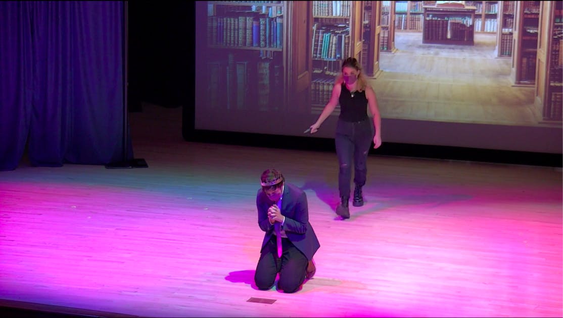 COURTESY OF RISHABH KUMAR
King Claudius, played by Feuerstein-Mendik, kneels while Hamlet, played by Al-Kowsi, stands behind him.