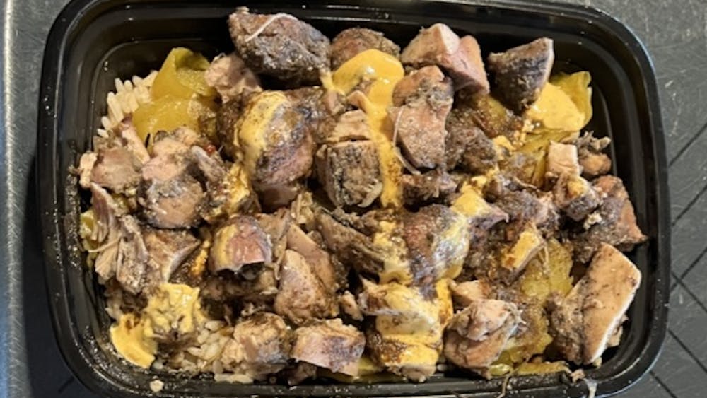 COURTESY OF ISABEL THOMAS
Thomas samples JBee’s Jamaican Me Crazy's Jerk Chicken Bowl, which she found delicious if overpriced.&nbsp;