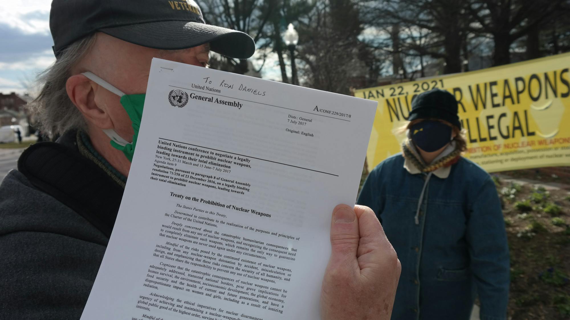 COURTESY OF CHRIS H. PARK
A protester holds up the text of the TPNW that he plans to tape on the door of the Nichols House where University President Ronald J. Daniels resides.