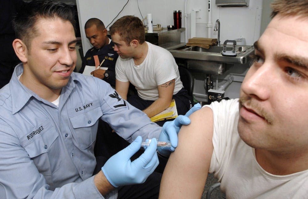 061218-N-5345W-053Portsmouth, Va. (Dec. 18, 2006) - Hospital Corpsman 3rd Class Ramon Rodriguez administers a typhoid vaccination during an annual checkup aboard the Nimitz-class aircraft carrier USS Harry S. Truman (CVN 75). Truman is currently conducting a simulated five-day fast cruise while nearing the end of a Docked Planned Incremental Availability (DPIA) period at Norfolk Naval Shipyard (NNSY) in Portsmouth, Va.  U.S. Navy photo by Mass Communications Specialist 3rd Class Kristopher Wilson (RELEASED)