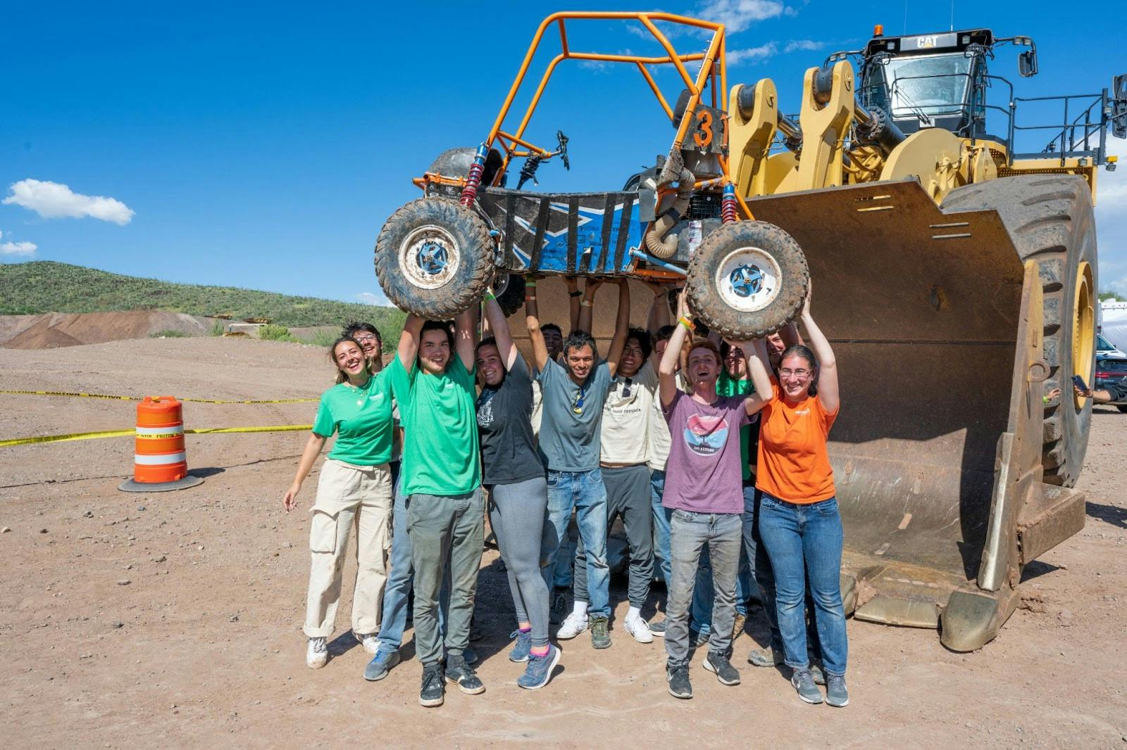 COURTESY OF LANCE PHILLIPS
Members of Hopkins Baja pose with their car at a Baja SAE competition.&nbsp;