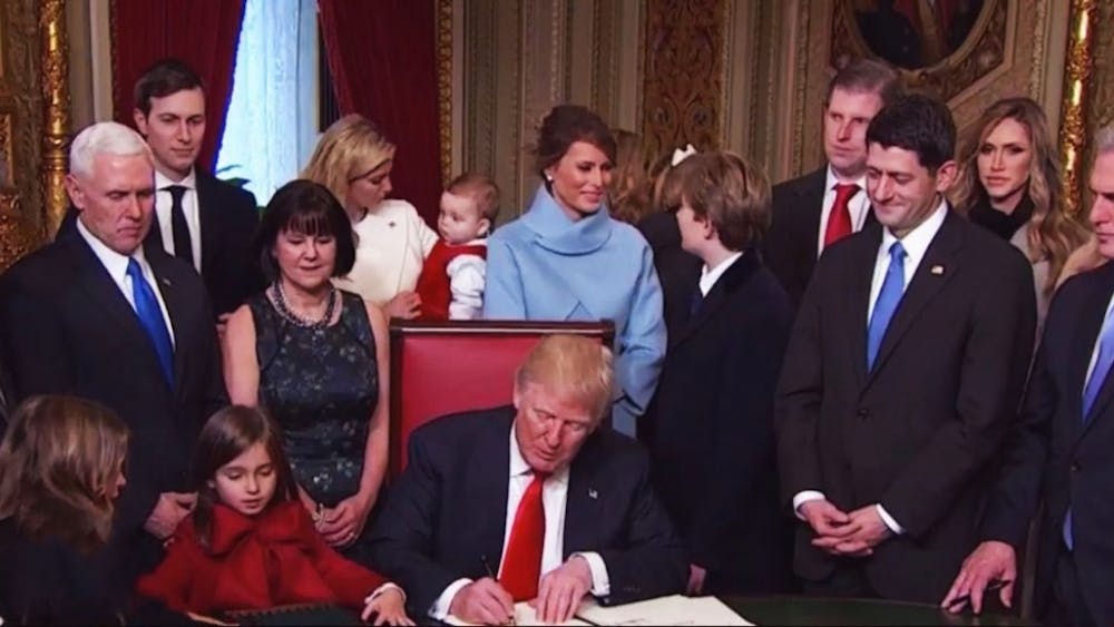  Karl-ludwig poggemann/cc by 2.0
President Donald Trump signs a stack of executive orders on Inauguration Day.