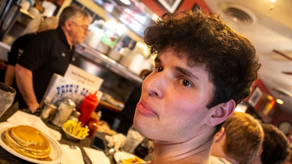 COURTESY OF DYLAN KWANG
Hecksher-Gomes stares off as a menacing short stack of pancakes awaits.