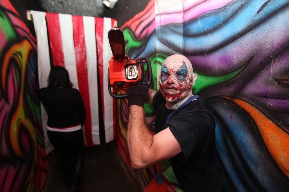 A clown rushes oncomers at the Panic Attack haunted attraction in Wilmington, N.C. Oct. 18. Panic Attack is one of the largest haunted houses in North Carolina, and is convienently located in proximity to Marine Corps Base Camp Lejeune and Marine Corps Air Station New River, 