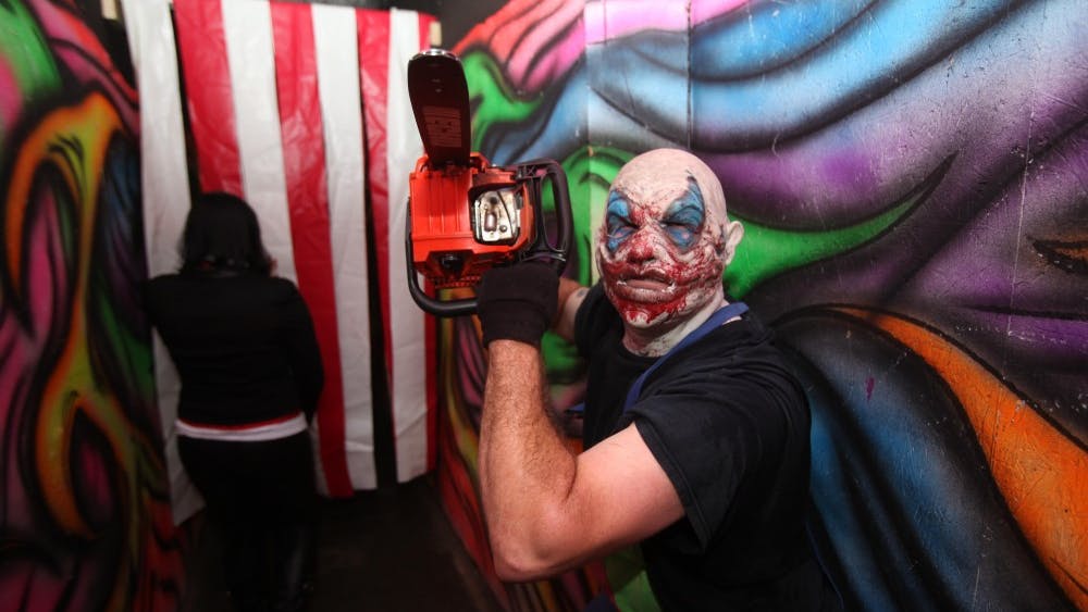 A clown rushes oncomers at the Panic Attack haunted attraction in Wilmington, N.C. Oct. 18. Panic Attack is one of the largest haunted houses in North Carolina, and is convienently located in proximity to Marine Corps Base Camp Lejeune and Marine Corps Air Station New River, 