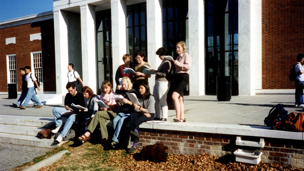 COURTESY OF THE UNIVERSITY ARCHIVES — SHERIDAN LIBRARIES&nbsp;
Members of the Student Labor Action Committee read in front of MSE Library circa 2000, around the time Valdez joined The News-Letter.