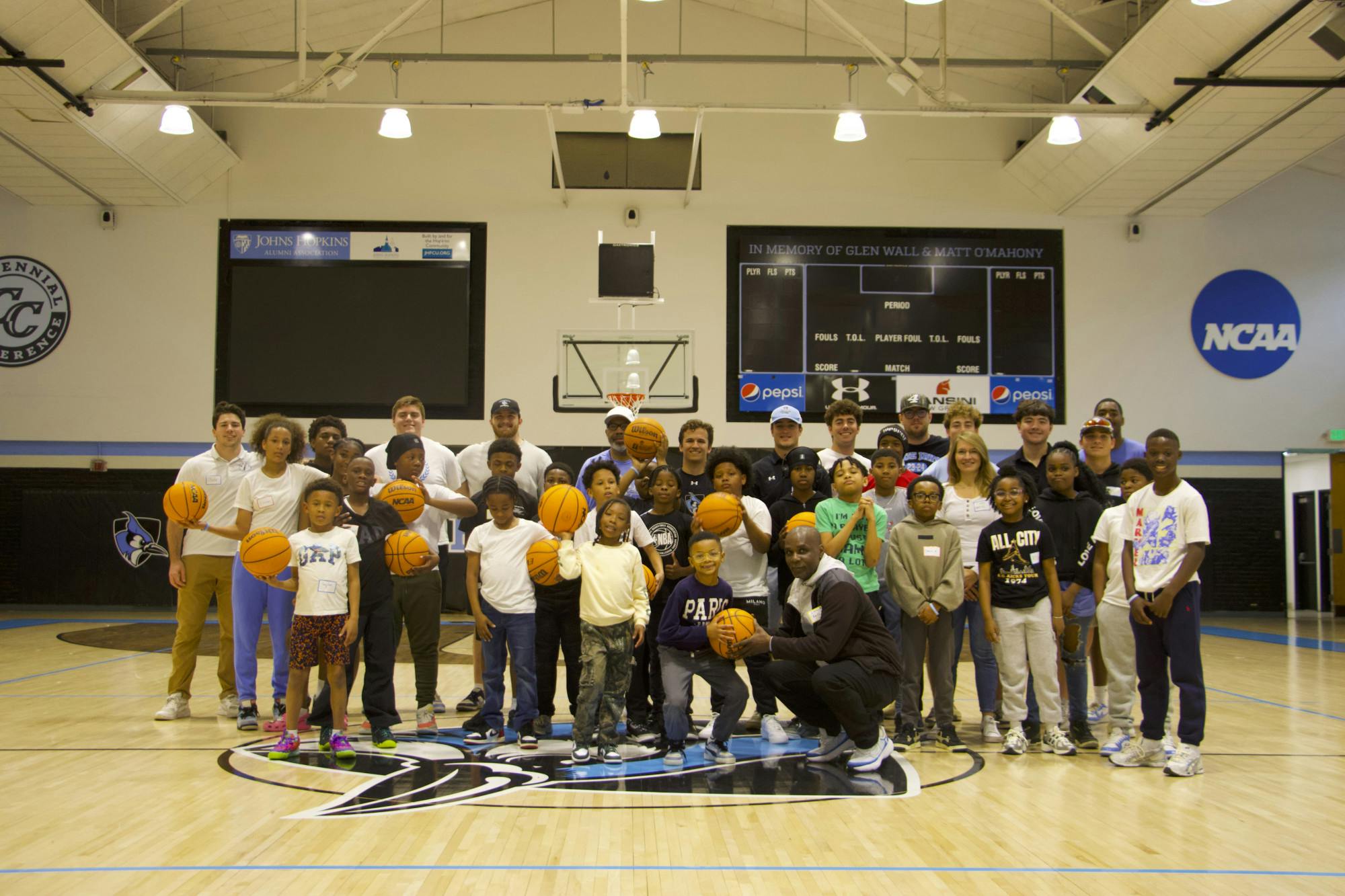 Courtesy of JULIA MENDES QUEIROZ
The Bentalou Center students, Coach Paul Franklin, Coach Kelly Phillips, Hopkins Football Athletes and Dr. Victoria Harms at the Larry Goldfarb Gymnasium.
