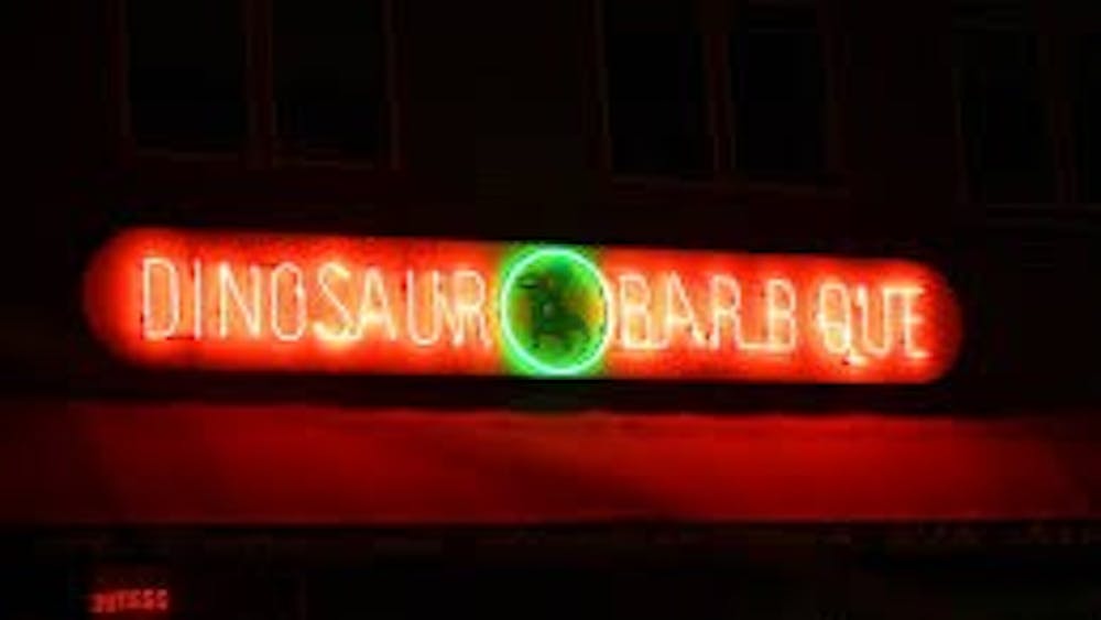JOSE VALCARCEL VIA FLICKR CC-BY-NC-SA-2.0
Each restaurant in the Dinosaur BBQ chain, which originated in Syracuse, bears  this logo above its doors.
