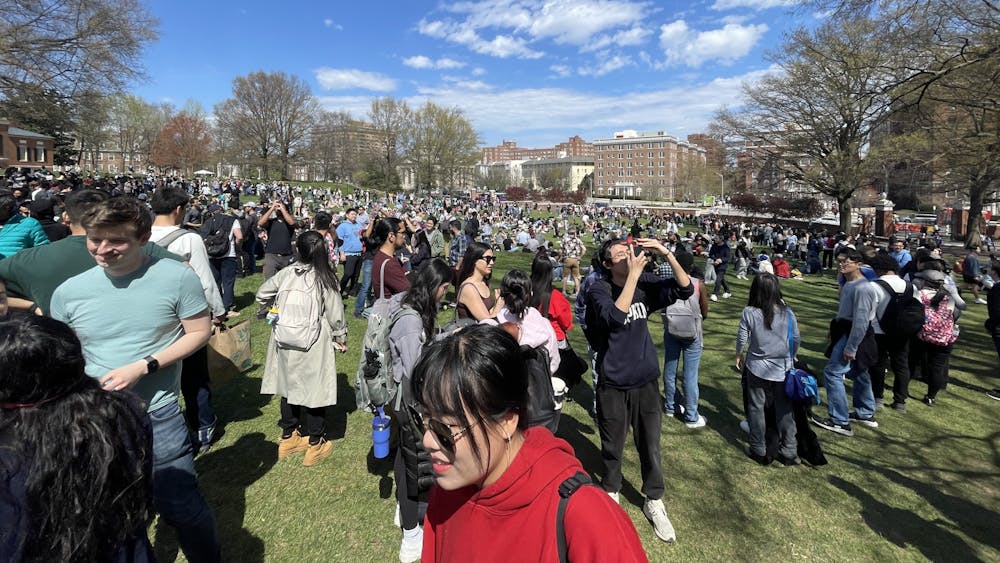 COURTESY OF ZACHARY BAHAR
Hopkins community members gather on the Beach to witness the total solar eclipse.