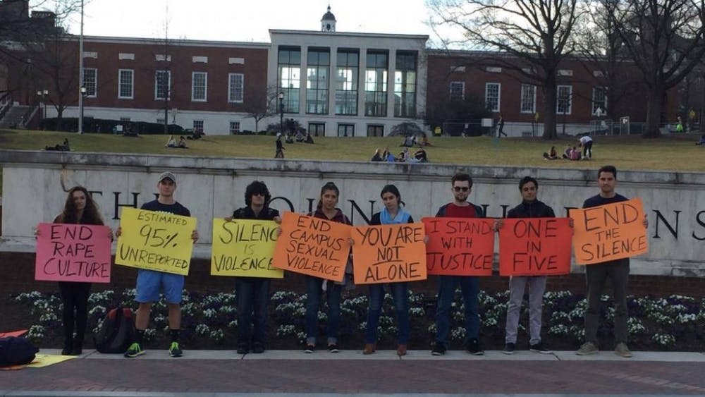 COURTESY OF NEHAL AGGARWAL
Students gathered in front of the Hopkins sign to protest sexual assault and call for transparency.