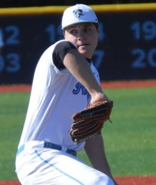 ELLIE HALLENBORG/PHOTOGRAPHY STAFF
Sophomore Nick Burns rears back and fires vs. New Paltz on Sunday.