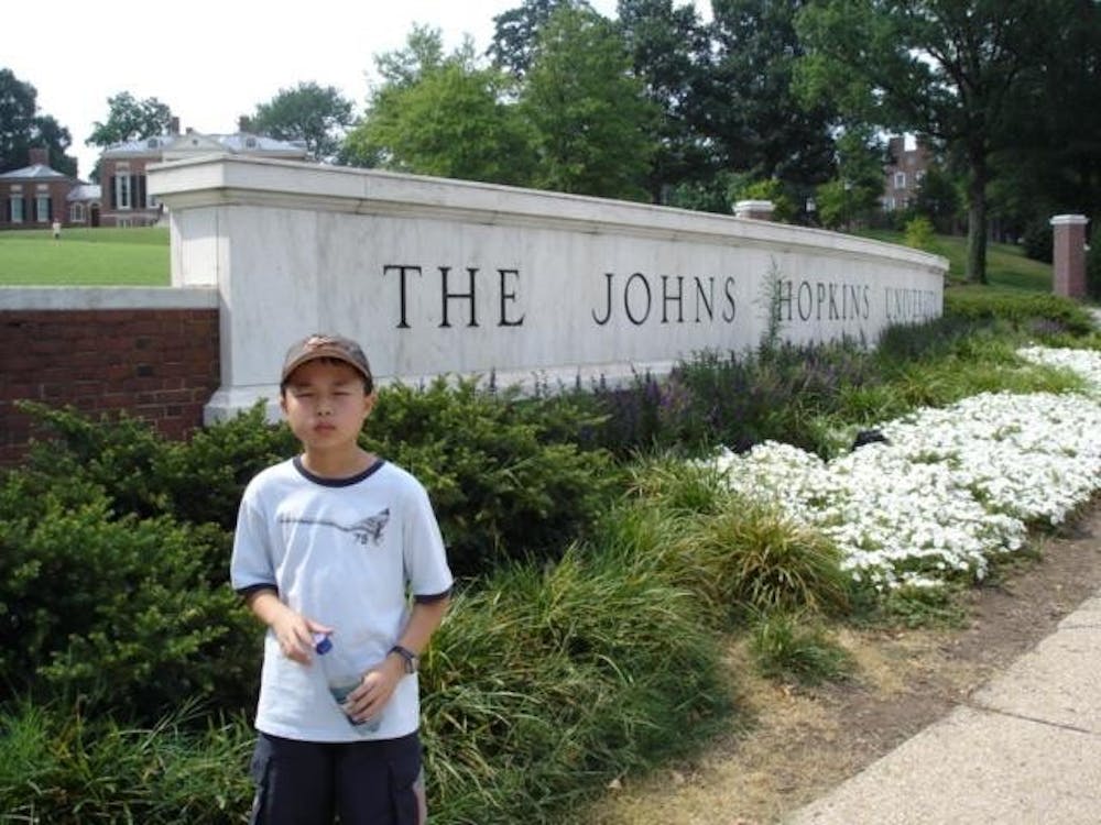 &nbsp;COURTESY OF ROLLIN HU
Hu, age 9 in the photograph, never imagined that he would attend Hopkins.