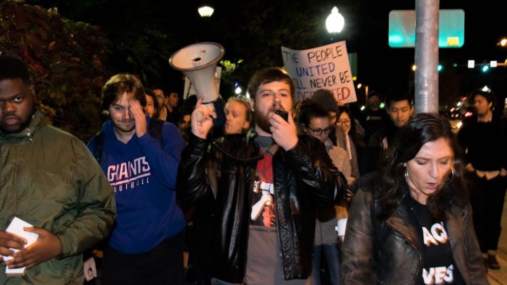  KAREEM OSMAN/PHOTOGRAPHY EDITOR
Since Trump's victory, activism has exploded on campus. Corey Payne is pictured at center with megaphone.