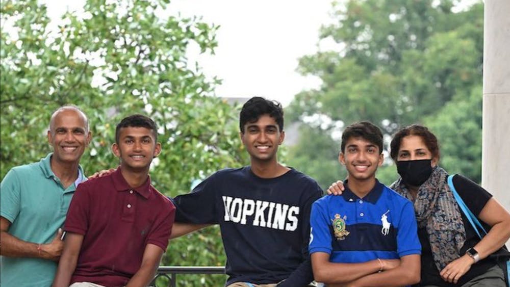 COURTESY OF RITWIK RAJ
Raj with his family on the Breezeway during New Student Orientation in 2021.