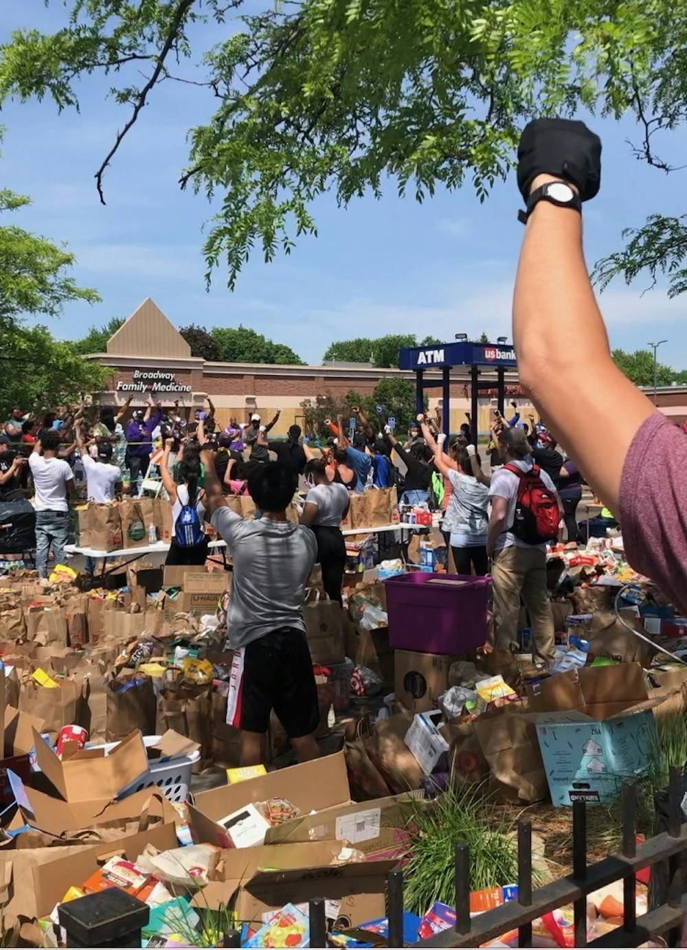 COURTESY OF ELISE MOORE
At a Minneapolis food bank, people placed their right fists over their hearts, raised their left fists in the air and held their breath for 10 seconds in memory of George Floyd.&nbsp;