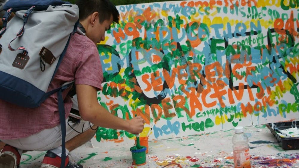  COURTESY OF NANCY WANG
Students painted words associated with poverty outside Levering.