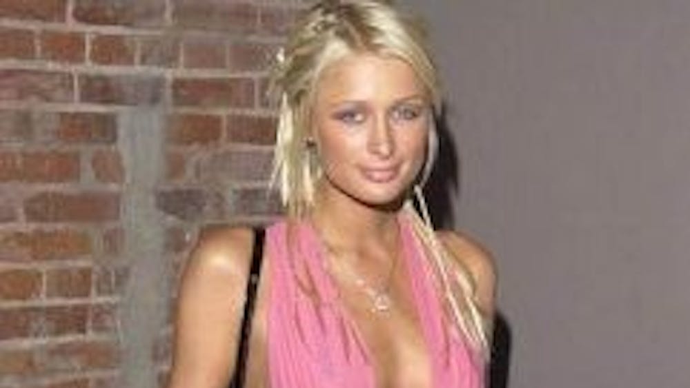 THEMEPLUS/CC-By-SA-2.0
Paris sports her signature pink in the form of a bikini-top-scarf-shirt. Her style has “inspired” many.