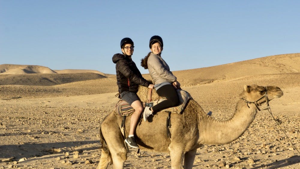 Courtesy of Rudy Malcom
Malcom and sophomore Sabrina Sussman on a camel near the Kfar Hanokdim oasis.