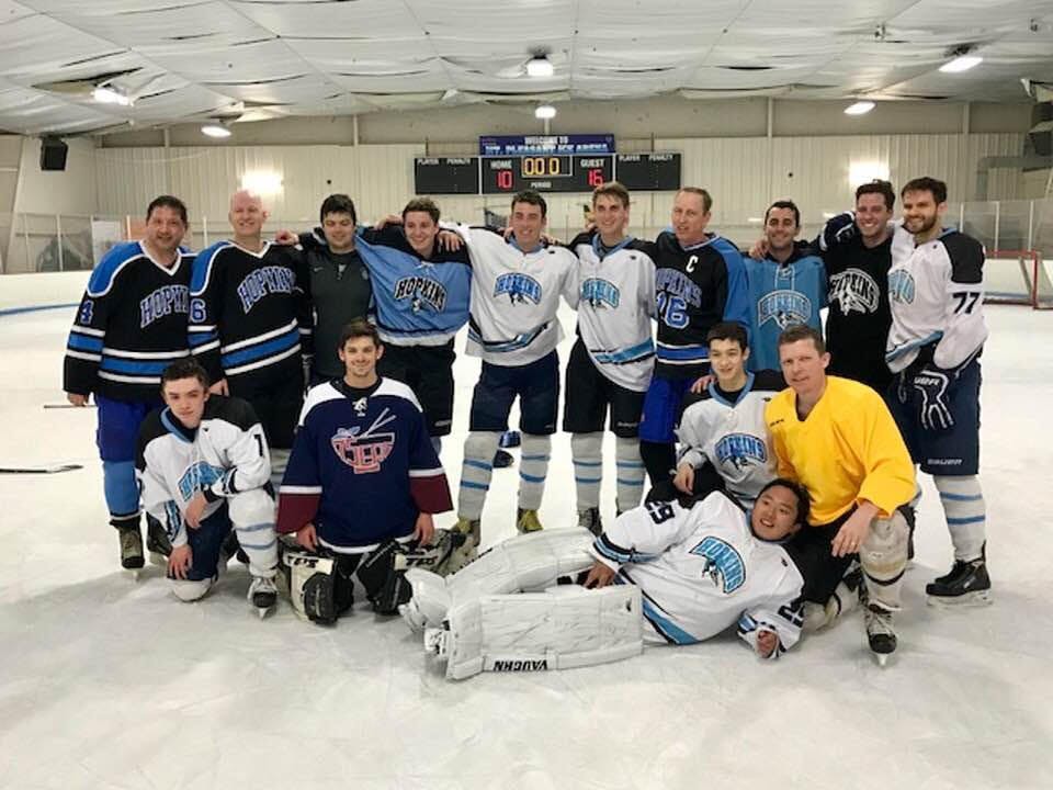 COURTESY OF ANDREW GRAY
Gray (standing, fourth from right) and Bill Dwyer (far left) attend an alumni hockey game in 2018, having started the club in the ‘80s.