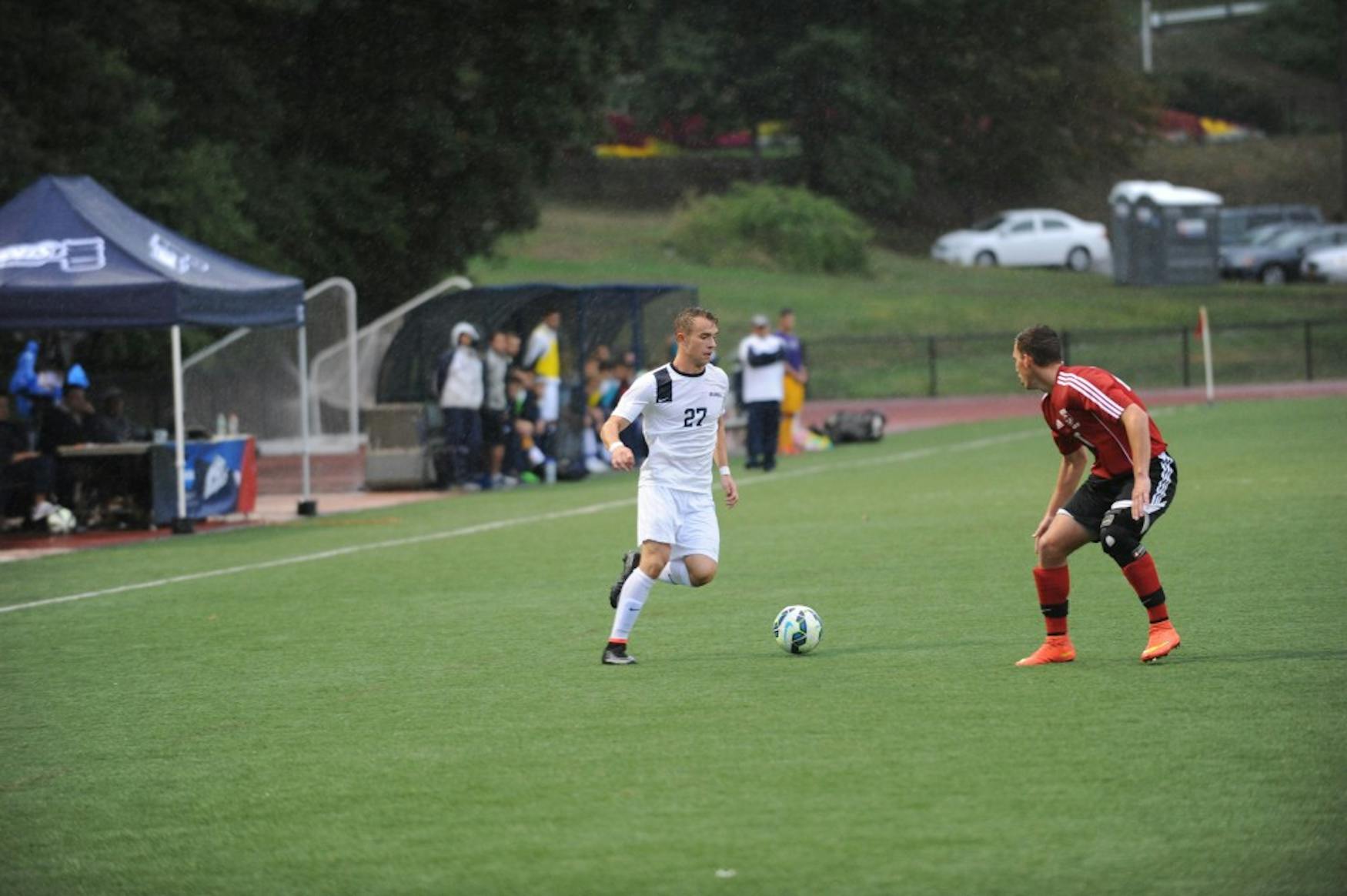 UP TO THE TASK: Forward Evan Jastremski ’17 (left) looks past a Clark University defender during the team’s 4-0 win on Saturday.