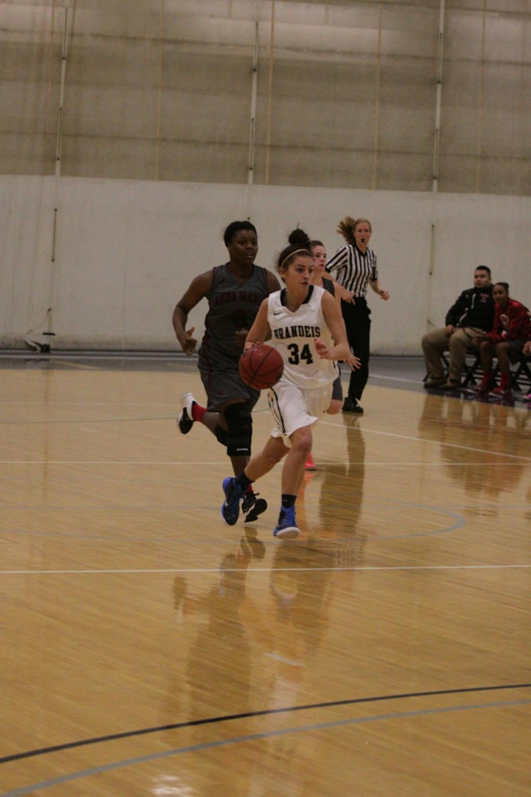 UPCOURT: Guard Heather Cain ’16 brings the ball up court in a 65-38 victory against Anna Maria College on Dec. 2.