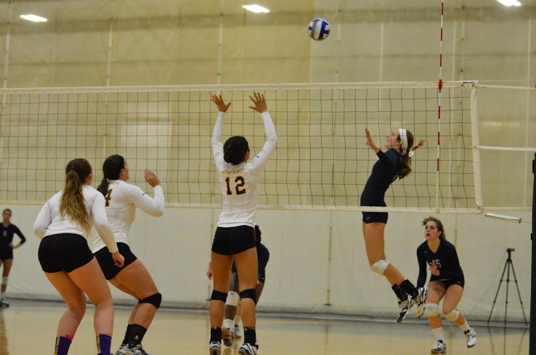 CUT SHOT: Outside Hitter Liz Hood ’15 (center) prepares a spike during the Judges’ sweep of Emerson College on Thursday.