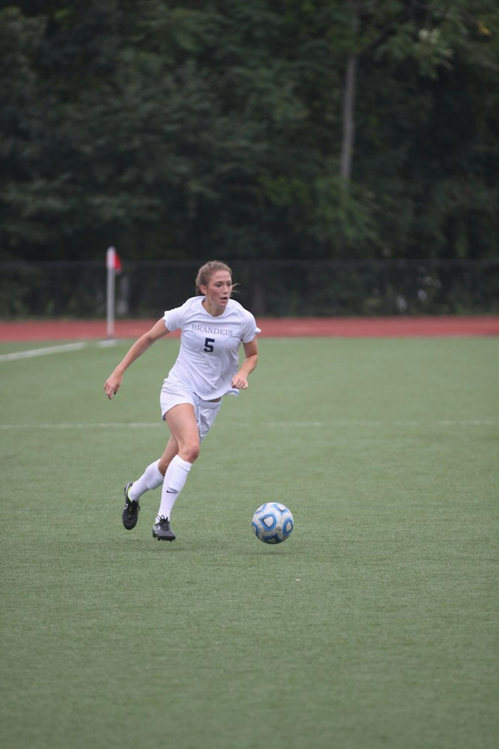 LEAPING AHEAD: Midfielder Mathilde Robinson ’16 brings the ball forward during a 3-0 victory over UMass Boston on Saturday.