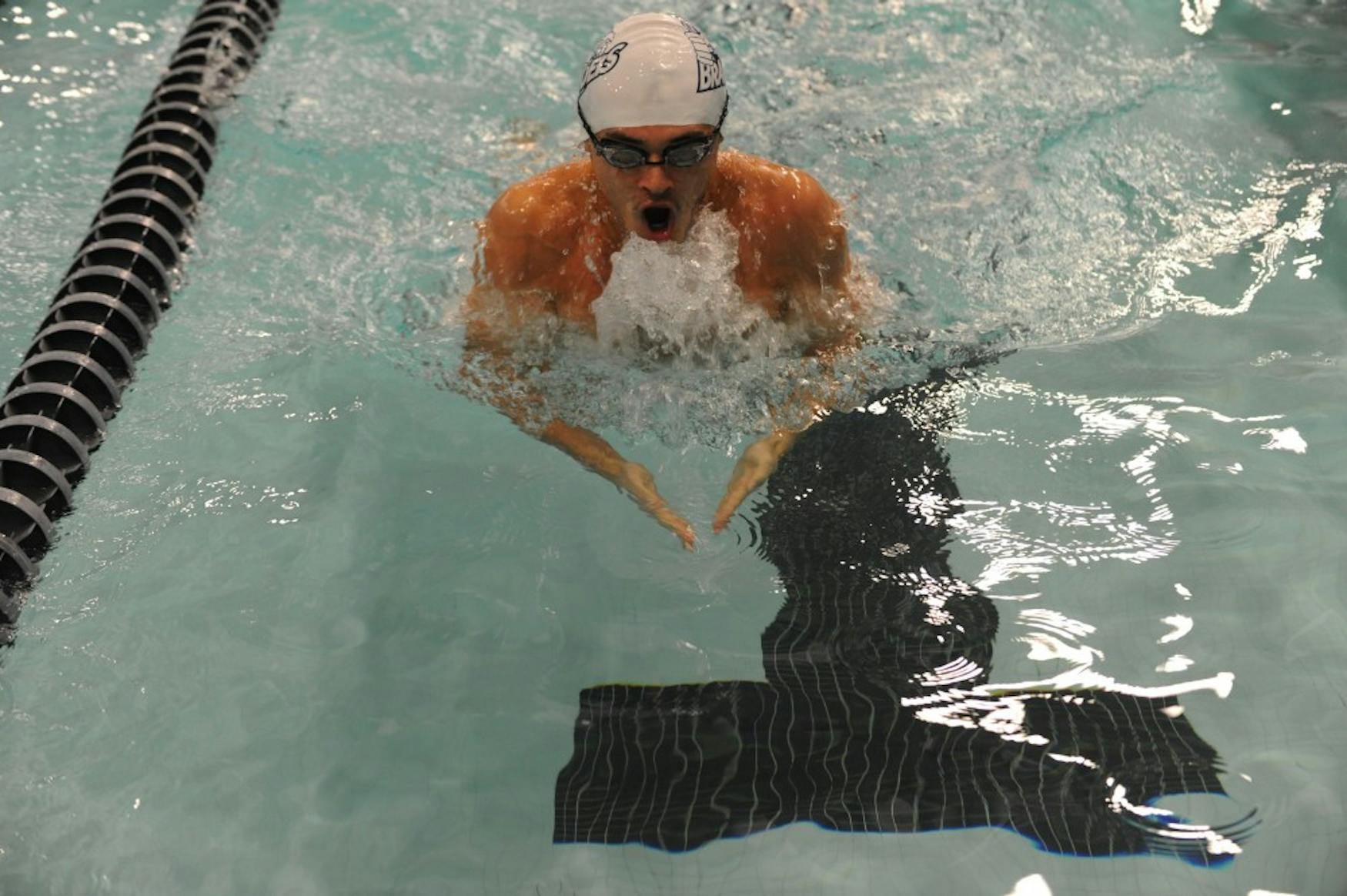 COMING UP FOR AIR: Freestyle swimmer Cameron Braz ’17 competes in a meet against Bridgewater State University on Friday.