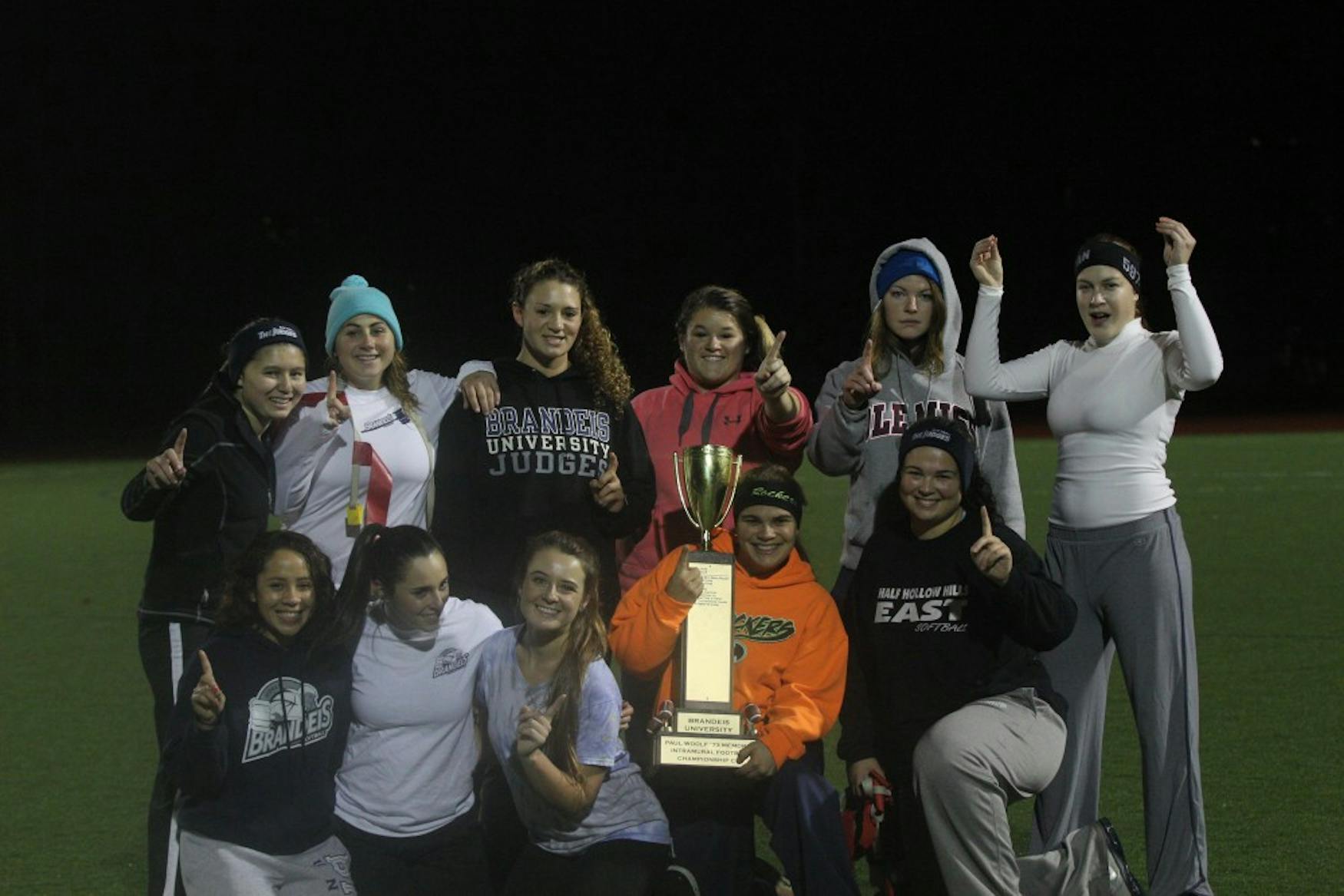 ALL SMILES: Members of Johnny Softball pose with the championship trophy following their victory in last week’s intramural final.