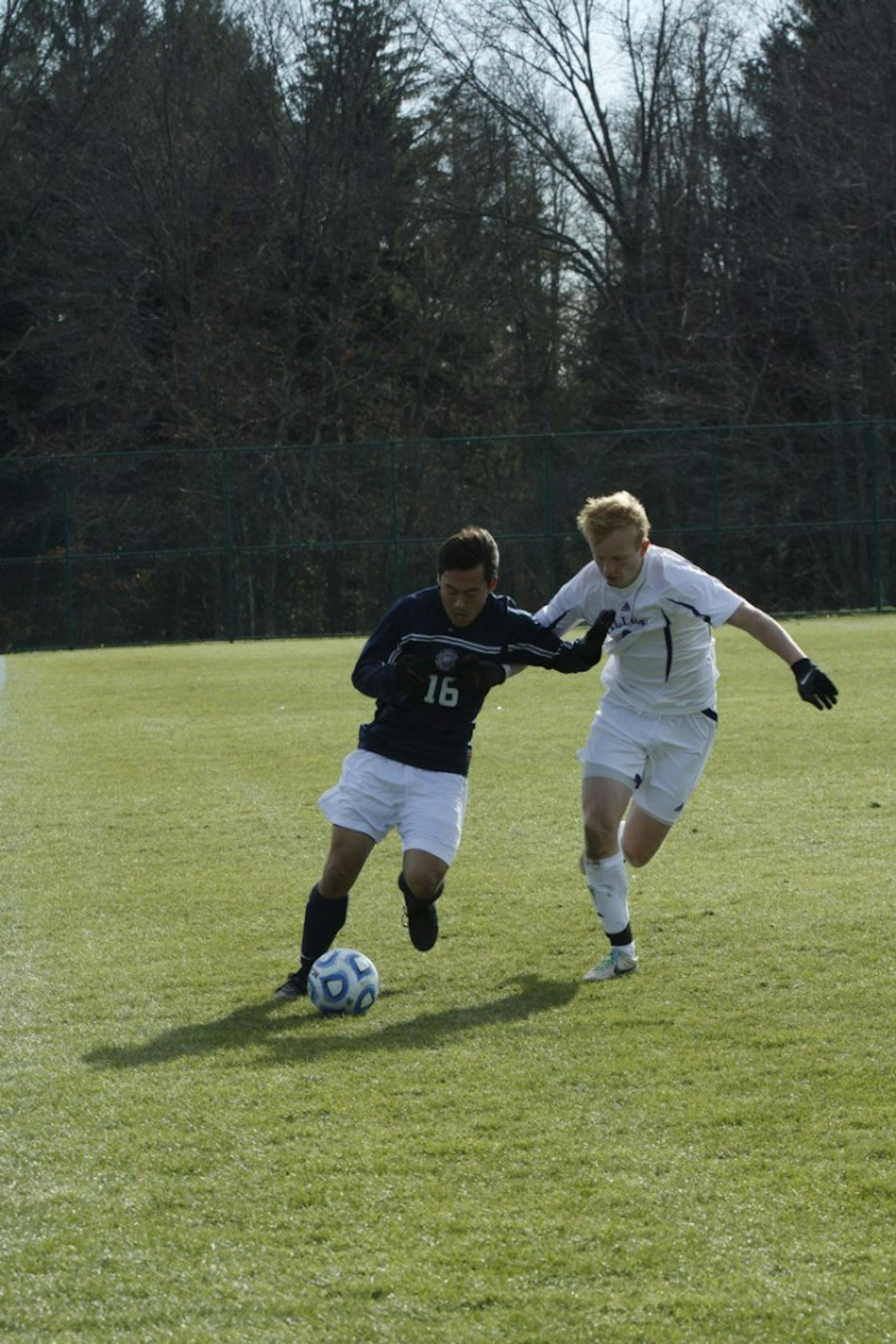 Defender Josh Hacunda ’16 (left) keeps the ball away from a Williams College opponent in a 2-0 loss last November.